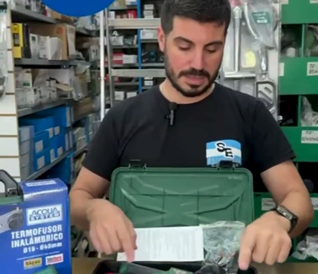Un vendedor de SANITARIOS ESCOBAR muestra en el mostrador un kit de termofusora inalámbrica