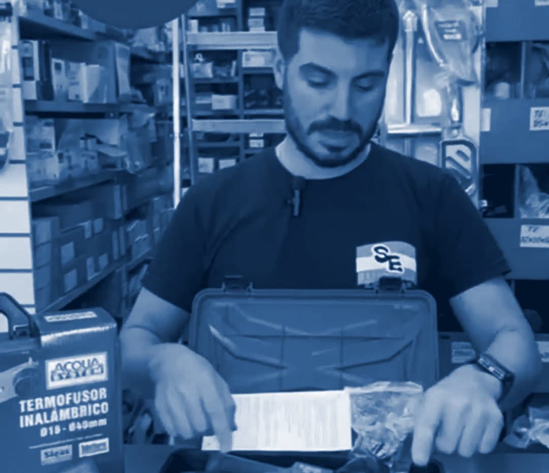 Un vendedor de SANITARIOS ESCOBAR muestra en el mostrador un kit de termofusora inalámbrica